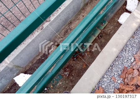 Rolling Gate Detail Showing Tracks, Ground Surface, and Nearby Vegetation in an Outdoor Setting Rolling Gate Detail Showing Tracks, Ground Surface, and Nearby Vegetation in an Outdoor Setting 130197317