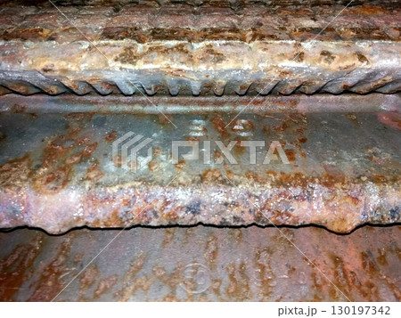 Melted Burner Grates Reveal Signs of Wear and Tear From Extensive Use in Kitchen Setting 130197342