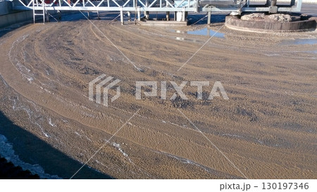 Surface of Water Covered With Mud in Treatment Plant During Processing Activities in Daylight 130197346