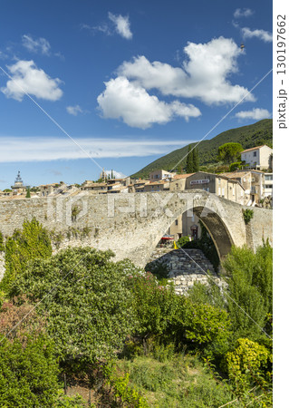 Old stone bridge leading to the village of Nyons in Drome Provencale, France 130197662