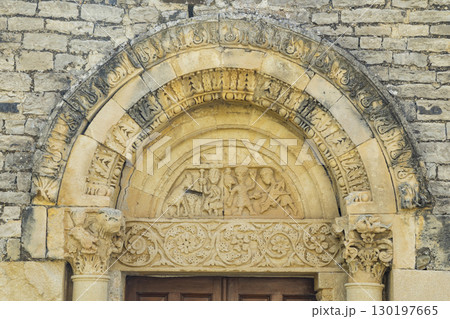 Intricately carved romanesque tympanum depicting biblical scenes at Sainte Jalle church in France Intricately carved romanesque tympanum depicting biblical scenes at Sainte Jalle church in France 130197665