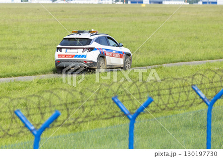 Airport security car patrolling near barbed wire fence in Hostivice, Czechia Airport security car patrolling near barbed wire fence in Hostivice, Czechia 130197730