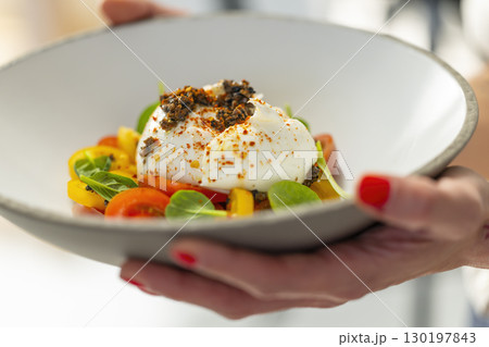 Chef Holding Plate of Burrata Cheese with Salad and Truffle Chef Holding Plate of Burrata Cheese with Salad and Truffle 130197843