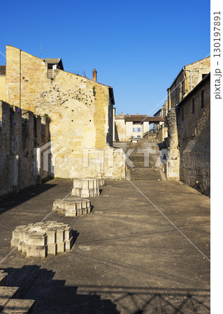 Ruins of Cluny Abbey showing the bases of the columns and the staircase leading to Place de l'Abbaye in Cluny, France 130197891
