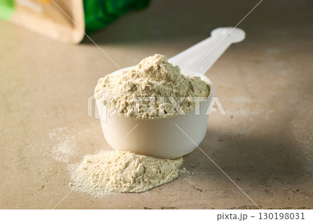 protein powder in scoop. dry mixture for preparation of sporting or dietary drink. protein powder in scoop. dry mixture for preparation of sporting or dietary drink. 130198031