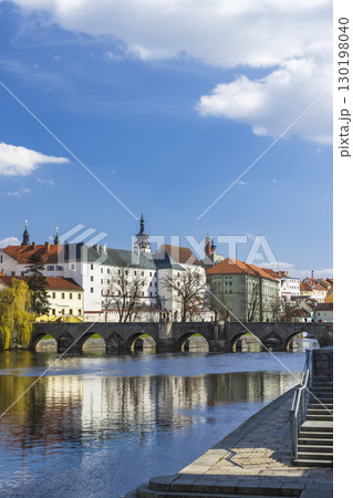 Stone Bridge reflecting on Otava River in Pisek, Czechia 130198040
