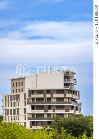 Modern Apartment Building with Balconies in Montpellier, France, under a Blue Sky 130198050