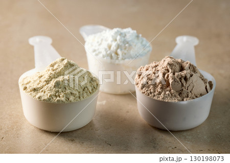 protein powder in scoops. dry mixture for preparation of sporting or dietary drink. 130198073
