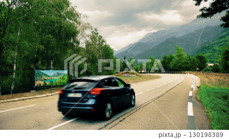 Mountain road with welcome sign to Allemond in French Alps 130198389
