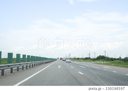 A one-way track, cars are driving along the road. 130198597