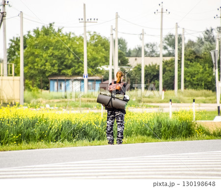 Hitchhiking. Girl auto-stopper. The girl with the backpack stops the car. Voting on the track. 130198648