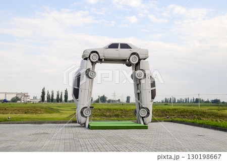 Homemade sculpture of three cars. Monument to the cyrillic lette 130198667