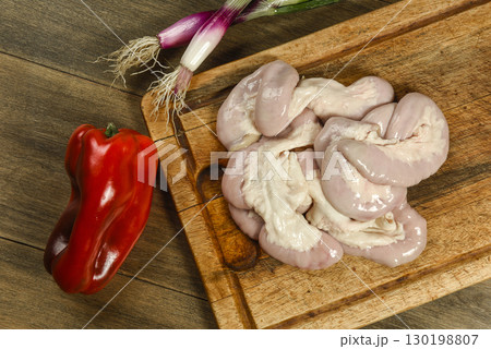 Cow bowels presented on a wooden board with ingredients, ready to grill 130198807
