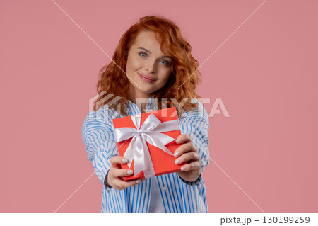 Happy Charming Woman Gift Box On PInk Background. Young Girl Smiling,Gives You Happy Charming Woman Gift Box On PInk Background. Young Girl Smiling,Gives You 130199259