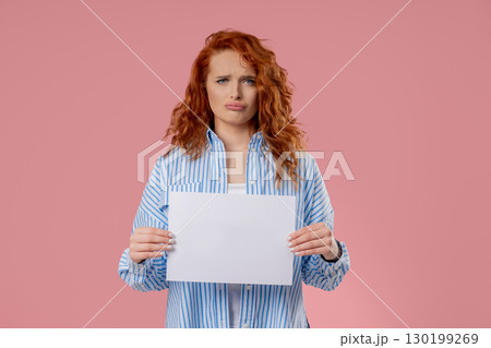 Young Sad Woman Holding Blank Billboard In Hands On Pink. Copy space, Mockup 130199269