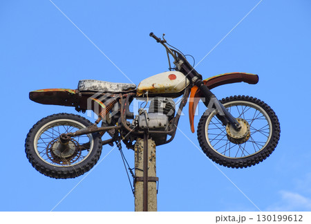 Motorcycle on the pedestal. A light motorbike on a pole, put up 130199612