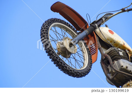 Motorcycle on the pedestal. A light motorbike on a pole, put up 130199619