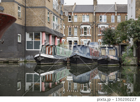 a dock for three narrowboats situated between an Edwardian-style terrace of houses. 130200227