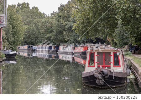 Narrowboats and Houseboats moored on the water alongside the Grand Union Canal. 130200228