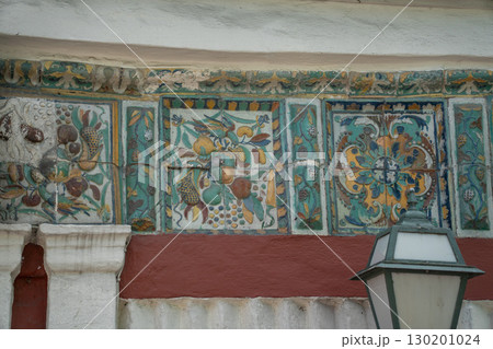 Ornate ceramic tilework featuring a winged seraphim face, floral motifs, and Orthodox Christian symbols in rich green, yellow, blue, and red tones 130201024