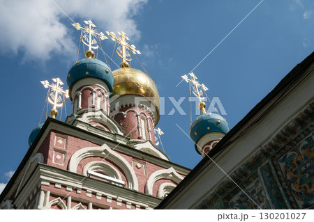 Ornate domes of the Assumption Church (Uspenskaya) in Taganka district, Moscow, with gleaming golden and blue cupolas crowned by Orthodox crosses Ornate domes of the Assumption Church (Uspenskaya) in Taganka district, Moscow, with gleaming golden and blue cupolas crowned by Orthodox crosses 130201027