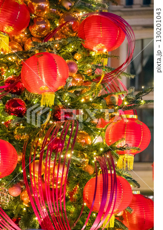 A tree decorated with red lanterns, gold ornaments, and festive lights in Moscow 130201043