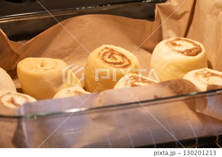 Raw cinnamon rolls before baking in the oven 130201213