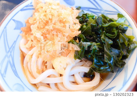 わかめ、天かすが盛られたうどん 130202323