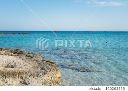 Transparent turquoise sea water and rocky beach, clean seabed and rescue buoys in the water Transparent turquoise sea water and rocky beach, clean seabed and rescue buoys in the water 130203366