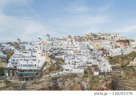 Greek town Oia on the island of Santorini - a magnet for tourists from around the world, drone photo Greek town Oia on the island of Santorini - a magnet for tourists from around the world, drone photo 130203376