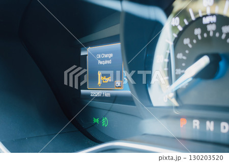 Oil change alert on a car dashboard display Oil change alert on a car dashboard display 130203520