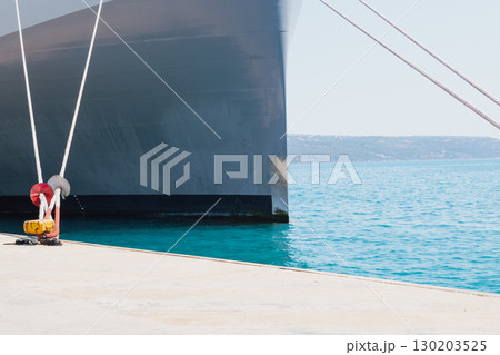 Mooring of a vessel in the port using mooring lines to a bollard on the quay Mooring of a vessel in the port using mooring lines to a bollard on the quay 130203525