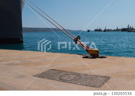 Mooring of a vessel in the port using mooring lines to a bollard on the quay 130203538