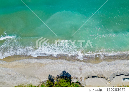 Overhead drone perspective of shoreline and sparkling foamy waves, ideal background Overhead drone perspective of shoreline and sparkling foamy waves, ideal background 130203673