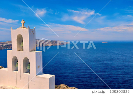 Traditional Greek White chapel of Agios Nikolaos in Megalochori and deep blue sea, Santorini island Traditional Greek White chapel of Agios Nikolaos in Megalochori and deep blue sea, Santorini island 130203823