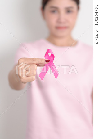 Pink October Breast Cancer Awareness month, woman with pink Ribbon for concepts of support people life and illness. National cancer survivors month, Women Health day and February World cancer day 130204751