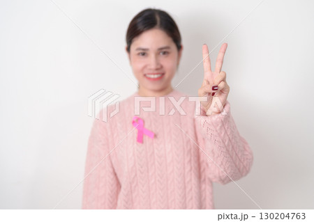 Pink October Breast Cancer Awareness month, woman with pink Ribbon for concepts of support people life and illness. National cancer survivors month, Women Health day and February World cancer day 130204763