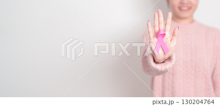 Pink October Breast Cancer Awareness month, woman with pink Ribbon for concepts of support people life and illness. National cancer survivors month, Women Health day and February World cancer day Pink October Breast Cancer Awareness month, woman with pink Ribbon for concepts of support people life and illness. National cancer survivors month, Women Health day and February World cancer day 130204764