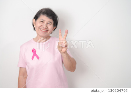 Elderly woman with pink Ribbon for Pink October Breast Cancer Awareness month, May Women Health, February World cancer day, support people life and illness. National cancer survivors month 130204795