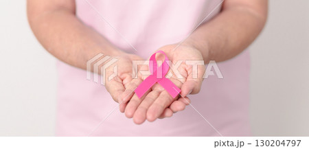 Elderly woman with pink Ribbon for Pink October Breast Cancer Awareness month, May Women Health, February World cancer day, support people life and illness. National cancer survivors month Elderly woman with pink Ribbon for Pink October Breast Cancer Awareness month, May Women Health, February World cancer day, support people life and illness. National cancer survivors month 130204797
