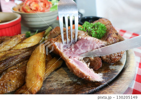 beef steak in gravy sauce or barbecued beef or grilled beef with French fries and vegetable salad 130205149