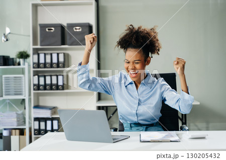 Business woman are delighted and happy with the work they do on their tablet, laptop and taking notes 130205432