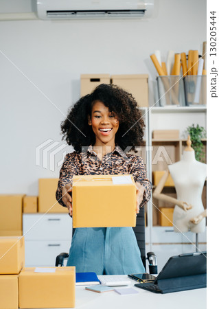 Startup small business SME, Entrepreneur owner woman using smartphone or tablet taking receive and checking online purchase shopping order Startup small business SME, Entrepreneur owner woman using smartphone or tablet taking receive and checking online purchase shopping order 130205444