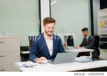 businessman working at office with laptop, tablet, and notes. Perfect for business, finance businessman working at office with laptop, tablet, and notes. Perfect for business, finance 130205882