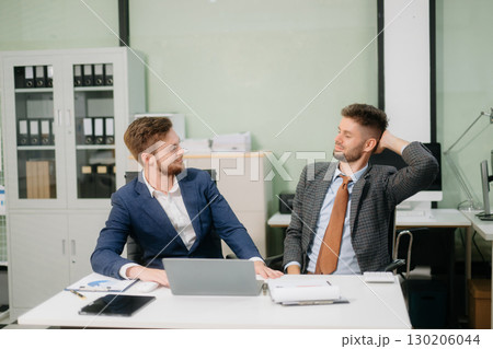 A stressed business team in shock after financial failure. Upset colleagues brainstorm solutions, reacting to bad news A stressed business team in shock after financial failure. Upset colleagues brainstorm solutions, reacting to bad news 130206044