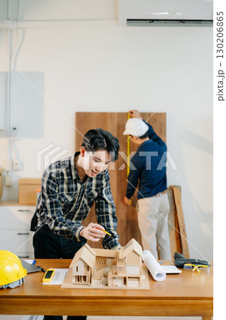 Architects and engineers collaborate on a building model, designing, planning, and measuring with teamwork, Architects and engineers collaborate on a building model, designing, planning, and measuring with teamwork, 130206865
