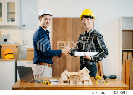 Engineer teams meeting working together wear worker helmets hardhat with on architectural project site Engineer teams meeting working together wear worker helmets hardhat with on architectural project site 130206913