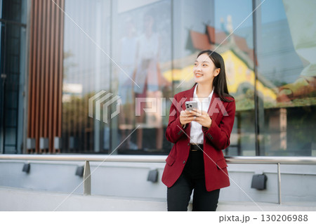 oung Asian business woman leader entrepreneur, professional manager holding digital tablet computer 130206988
