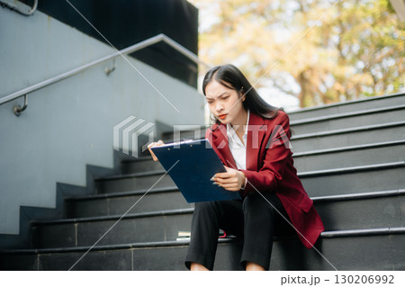 Young Asian business woman leader entrepreneur, professional manager holding digital tablet computer in big city Young Asian business woman leader entrepreneur, professional manager holding digital tablet computer in big city 130206992