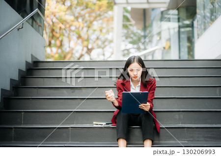 Young Asian business woman leader entrepreneur, professional manager holding digital tablet computer in big city Young Asian business woman leader entrepreneur, professional manager holding digital tablet computer in big city 130206993